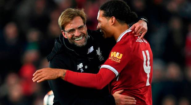 Liverpool's German manager Jurgen Klopp hugs Liverpool's Dutch defender Virgil van Dijk